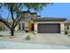 Charming home exterior with a well-maintained yard, driveway, and 2-car garage at 18515 N 97Th Way, Scottsdale, AZ 85255