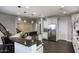 The spacious kitchen features dark granite countertops, white cabinets, stainless steel appliances, and an island with barstool seating at 18515 N 97Th Way, Scottsdale, AZ 85255