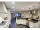 Open-concept kitchen featuring modern appliances, granite countertops, and hardwood floors at 18515 N 97Th Way, Scottsdale, AZ 85255