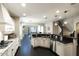Bright kitchen with dark floors, granite counters, stainless appliances, and ample counter space open to the living areas at 18515 N 97Th Way, Scottsdale, AZ 85255