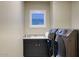 Well-organized laundry room equipped with modern appliances, ample cabinet space, and a practical sink at 18515 N 97Th Way, Scottsdale, AZ 85255
