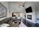 Spacious living room featuring a cozy fireplace, high ceilings, and dark wood floors at 18515 N 97Th Way, Scottsdale, AZ 85255