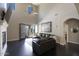 Grand living room with soaring ceilings, fireplace, abundant natural light, and seamless indoor-outdoor transition to backyard at 18515 N 97Th Way, Scottsdale, AZ 85255