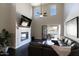 Inviting living room with fireplace, high ceilings, patio access and comfortable seating creating a cozy atmosphere at 18515 N 97Th Way, Scottsdale, AZ 85255