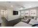 Spacious living room with a large sectional couch and dark wood floors at 18515 N 97Th Way, Scottsdale, AZ 85255