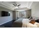 Comfortable main bedroom featuring tray ceilings, a ceiling fan, and dark wood floors at 18515 N 97Th Way, Scottsdale, AZ 85255