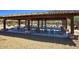 Shaded picnic area with stone pillars, multiple tables and bench seating perfect for neighborhood gatherings at 18515 N 97Th Way, Scottsdale, AZ 85255