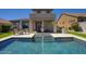 Stunning backyard features a pristine pool with integrated spa, outdoor kitchen, and covered patio for luxurious outdoor living at 18515 N 97Th Way, Scottsdale, AZ 85255