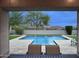 A picturesque view through a covered patio leads to a sparkling swimming pool with fountain features at 18515 N 97Th Way, Scottsdale, AZ 85255