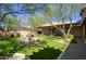 Landscaped backyard featuring a beautiful water fountain, covered patio, and mature trees at 18515 N 97Th Way, Scottsdale, AZ 85255