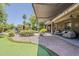 Relax and entertain in this backyard with covered patio, putting green and more at 18581 E Aubrey Glen Rd, Queen Creek, AZ 85142