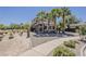 The back corner of this two-story home has desert landscaping and walkway at 18581 E Aubrey Glen Rd, Queen Creek, AZ 85142