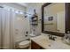 Cozy bathroom with shower-tub combo, stylish mirror, and neutral decor at 18581 E Aubrey Glen Rd, Queen Creek, AZ 85142
