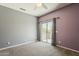 Bedroom with ample natural light and a sliding door for outdoor access at 18581 E Aubrey Glen Rd, Queen Creek, AZ 85142