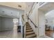 Open hallway and carpeted staircase next to a living area at 18581 E Aubrey Glen Rd, Queen Creek, AZ 85142