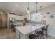 Stylish kitchen featuring quartz countertops, stainless steel appliances, and bar seating at 18581 E Aubrey Glen Rd, Queen Creek, AZ 85142