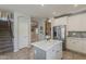 Bright kitchen featuring a center island, stainless steel refrigerator, and tile backsplash at 18581 E Aubrey Glen Rd, Queen Creek, AZ 85142