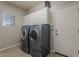 Convenient laundry room with washer, dryer, and overhead storage cabinets at 18581 E Aubrey Glen Rd, Queen Creek, AZ 85142