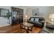 Comfortable living room with hardwood floors, leather seating, and decorative bookcase at 18581 E Aubrey Glen Rd, Queen Creek, AZ 85142