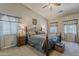 Spacious main bedroom with a ceiling fan, comfortable bed, and natural light at 18581 E Aubrey Glen Rd, Queen Creek, AZ 85142