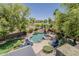 Aerial view of a backyard oasis with a pool, spa, landscaping, and lounge chairs at 18581 E Aubrey Glen Rd, Queen Creek, AZ 85142