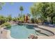 Sparkling pool with rock features and lush landscaping creates a backyard paradise at 18581 E Aubrey Glen Rd, Queen Creek, AZ 85142