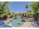 Beautiful pool with rock waterfall, hot tub, and mature landscaping at 18581 E Aubrey Glen Rd, Queen Creek, AZ 85142