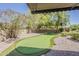 Artificial putting green in backyard with desert landscaping at 18581 E Aubrey Glen Rd, Queen Creek, AZ 85142