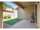 Covered back patio with artificial grass and a brick border at 19172 E Kingbird Dr, Queen Creek, AZ 85142