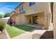 Private backyard features a manicured lawn, brick patio, and a partially covered patio space ideal for outdoor entertaining at 19172 E Kingbird Dr, Queen Creek, AZ 85142