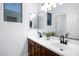 Bright bathroom features double sinks, dark fixtures, and a large mirror at 19172 E Kingbird Dr, Queen Creek, AZ 85142