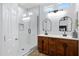 Bright bathroom features a glass-enclosed shower, double sink vanity with wood cabinetry, and stylish fixtures for a spa-like experience at 19172 E Kingbird Dr, Queen Creek, AZ 85142