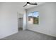 A bright bedroom features a ceiling fan, closet access, and a window with a view at 19172 E Kingbird Dr, Queen Creek, AZ 85142