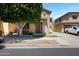 Charming two-story home with well-maintained landscaping, a lush tree, and a welcoming entrance creating curb appeal at 19172 E Kingbird Dr, Queen Creek, AZ 85142