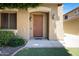 Inviting front entrance with a brown door, decorative lights, and well-maintained landscaping at 19172 E Kingbird Dr, Queen Creek, AZ 85142