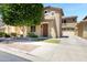 Charming two-story home with well-maintained landscaping, a lush tree, and a welcoming entrance creating curb appeal at 19172 E Kingbird Dr, Queen Creek, AZ 85142