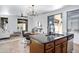 Open concept kitchen with stainless appliances, dark countertops, and adjoining living area at 19172 E Kingbird Dr, Queen Creek, AZ 85142