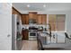 Updated kitchen with stainless steel appliances, dark countertops, and ample cabinet space at 19172 E Kingbird Dr, Queen Creek, AZ 85142