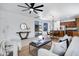 Open-concept living room features stylish furnishings, modern lighting, and seamless access to the kitchen and outdoor area at 19172 E Kingbird Dr, Queen Creek, AZ 85142