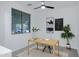 Home office with neutral walls, natural light, and a modern ceiling fan at 19172 E Kingbird Dr, Queen Creek, AZ 85142