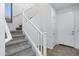 A staircase with carpeted steps leads to the upper level, bathed in natural light from a nearby window at 19172 E Kingbird Dr, Queen Creek, AZ 85142