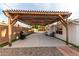 Outdoor patio featuring a grill, pergola, seating, and rock landscaping at 2001 W Surrey Ave, Phoenix, AZ 85029