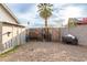 Spacious backyard featuring a gate, rock landscaping, and perimeter block fence at 2001 W Surrey Ave, Phoenix, AZ 85029