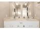 Bathroom featuring a double sink vanity with a large mirror and neutral color palette at 2001 W Surrey Ave, Phoenix, AZ 85029