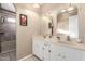 Bathroom featuring double sinks and tiled shower at 2001 W Surrey Ave, Phoenix, AZ 85029