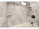Bright bathroom featuring a tiled shower and multiple shelves for toiletries at 2001 W Surrey Ave, Phoenix, AZ 85029