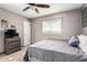 Cozy bedroom features a queen bed, ceiling fan, window and dresser at 2001 W Surrey Ave, Phoenix, AZ 85029