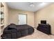 Bedroom with simple features with tiled floors, a bed, and a TV stand at 2001 W Surrey Ave, Phoenix, AZ 85029