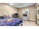 Cozy bedroom with a sports-themed blanket, window and a ceiling fan at 2001 W Surrey Ave, Phoenix, AZ 85029