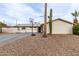 Charming single-story home with a desert landscaped yard and a basketball hoop at 2001 W Surrey Ave, Phoenix, AZ 85029